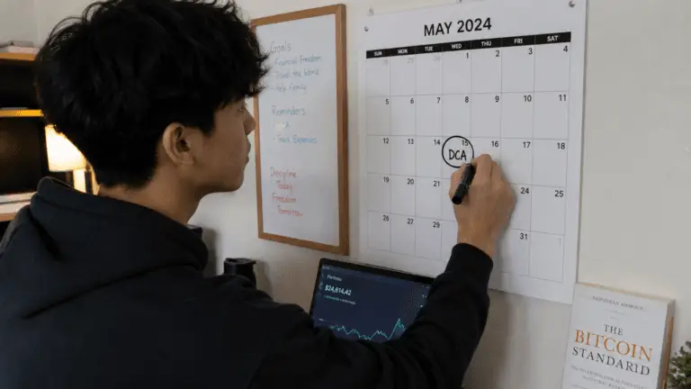 A young adult pointing out dollar cost averaging (DCA) in his calendar.